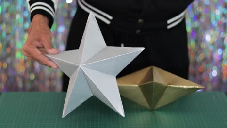 DIY-silver-and-golden-star-decors-for-Christmas-tree-decoration,-closeup-on-cutting-mat