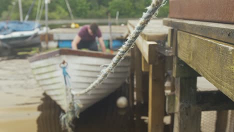 A-young-man-bails-out-a-fiberglass-fishing-boat