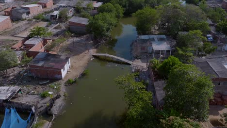 Aerial-drone-shot-over-poor-neighborhood-in-Cartagena-and-a-child-crosses-the-bridge