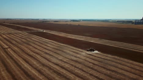 Rising-Drone-Shot-Pair-of-Combines-Farming-a-Single-Crop-of-Land-in-the-Midwest