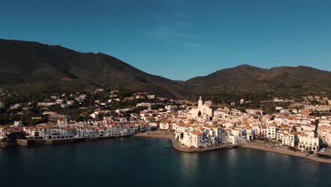 Cinematic-aerial-view-over-a-beautiful-coastal-village-surrounded-by-gorgeous-white-houses-on-the-Costa-Brava-of-Spain