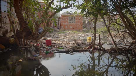 Una-Casa-Pobre-Junto-A-Un-Río-Está-Rodeada-De-Basura