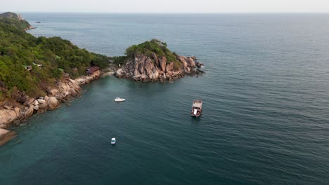 Drone-view-over-boats-in-ocean-during-sunset