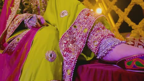 An-Asian-bride-photo-shoot-at-the-event-of-Mehndi,-A-close-up-of-her-foot-wear-and-dress