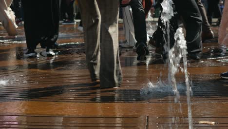 Legs-of-People-dancing-on-fountain-on-Kultorvet-square-on-sunny-day
