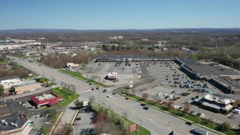 4K-Aerial-Drone-footage-of-industrial-shopping-centers-and-strip-malls-in-Middletown-New-York-and-traffics-can-be-seen-with-mountains-in-the-background