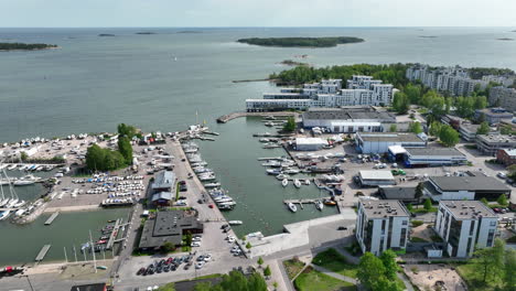 Aerial-tracking-shot-of-boats-at-the-Lauttasaari-marina,-in-sunny-Helsinki,-Finland