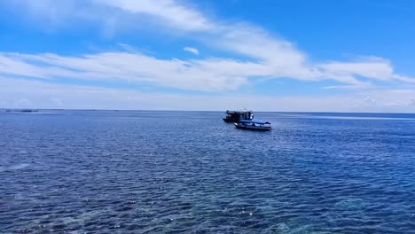 Boat-sails-in-the-ocean-on-Karampuang-Island,-Mamuju,-West-Sulawesi,-Indonesia