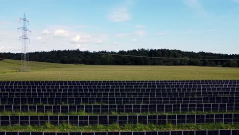 Aerial-push-over-solar-energy-farm-among-lush-gold-and-green-fields