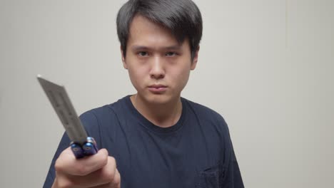 Portrait-Of-A-Chinese-Man-Holding-A-Balisong-Butterfly-Knife