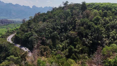 Una-Vista-Panorámica-De-Una-Hermosa-Carretera-Que-Serpentea-A-Través-De-Un-Bosque-En-Songklaburi,-Tailandia,-Que-Ofrece-Un-Recorrido-Panorámico-En-Medio-De-Una-Exuberante-Vegetación