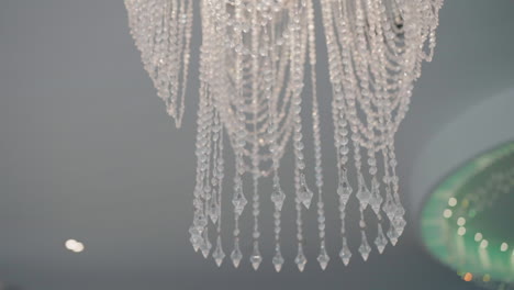 Elegant-crystal-chandelier-with-intricate-design-in-a-stylish-salon