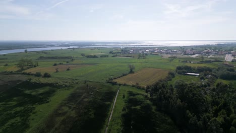 Expansive-aerial-shot-of-Aveiro-Ria-with-lush-fields,-Portugal