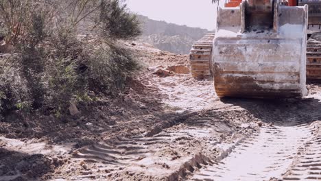 Close-up-of-a-bulldozer's-blade-and-tracks-working-on-a-construction-site