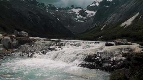 Water-From-Esmeralda-Lagoon-Flowing-To-The-River-In-Ushuaia,-Tierra-del-Fuego,-Argentina