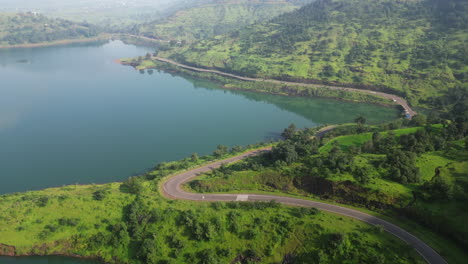 Aerial-view-of-road-between-Bahuli-waterfall-and-green-trees-Nashik-Maharashtra