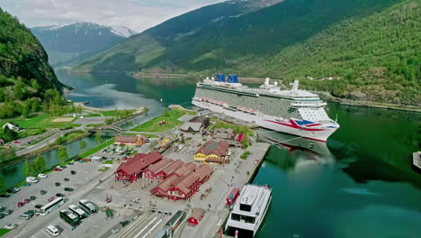 Aerial-View-of-Cruise-Ship-and-Flam-Port,-Norway,-Popular-Tourist-Destination-on-Sunny-Day,-Drone-Shot