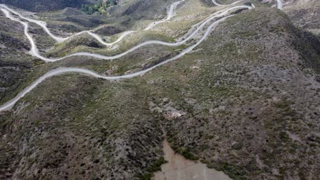 Flyover-reveals-twisted-switchbacks-as-road-descends-mountain-pass