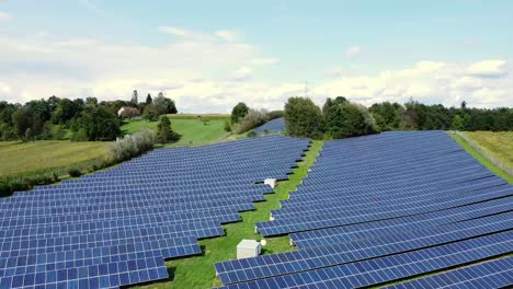 Retreating-aerial-view-over-photovoltaic-system,-farmland-surrounding