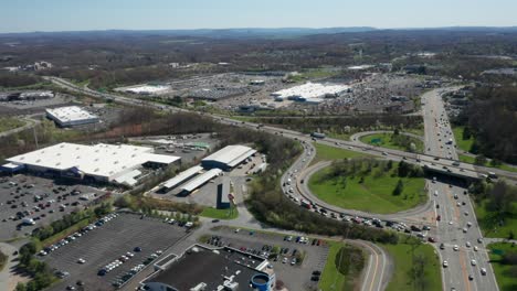 4K-Aerial-Drone-footage-of-industrial-shopping-centers-and-strip-malls-in-Middletown-New-York-and-traffics-can-be-seen-with-mountains-in-the-background