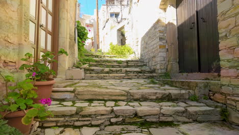 Rustic-stone-stairway-flanked-by-old-walls-and-potted-plants,-typical-of-a-traditional-Lefkara-village-pathway,-under-a-bright-sky