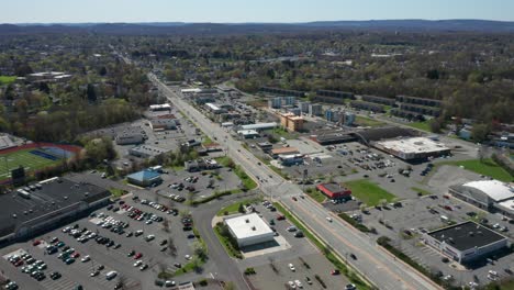 4K-Aerial-Drone-footage-of-industrial-shopping-centers-and-strip-malls-in-Middletown-New-York-and-traffics-can-be-seen-with-mountains-in-the-background