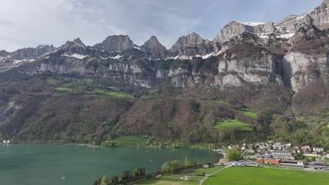 Lakeside-tranquility-where-Walensee-meets-the-majestic-Churfirsten-range,-Switzerland---aerial