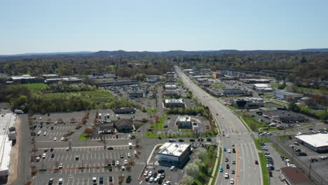 4K-Aerial-Drone-footage-of-industrial-shopping-centers-and-strip-malls-in-Middletown-New-York-and-traffics-can-be-seen-with-mountains-in-the-background