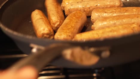 Sausages-Being-Cooked-and-Shaken-in-Frying-Pan-by-Chef