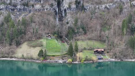 Houses-perched-over-Lake-Walensee-in-the-quaint-village-of-Quinten,-Switzerland,-offering-a-picturesque-lakeside-setting