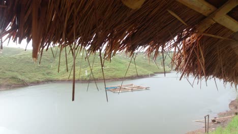 Rain-drops-drip-from-cogon-roof,-Loboc-river-near-Chocolate-hills,-Philippines