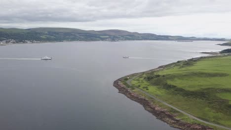 Two-Ferries-Carrying-Passengers-Between-Ports,-Aerial-Scotland