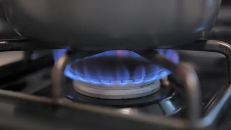 Gas-Stove-Top-with-blue-flames-under-a-pot