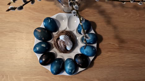 Azure-Easter-eggs-adorned-with-intricate-markings,-nestled-in-a-wicker-basket-against-a-pristine-white-backdrop