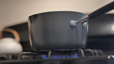 Pot-on-top-of-stove-with-blue-gas-flame-under