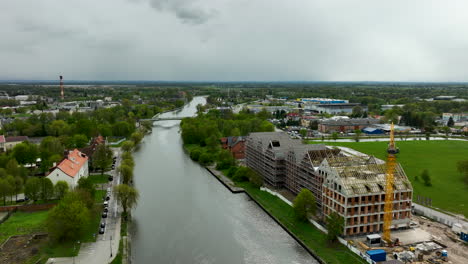 Sitio-De-Construcción-En-El-Río-Con-Grúa-En-La-Pequeña-Ciudad-Polaca-De-Elblag,-Polonia