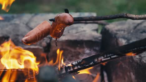 Roasting-sausages-on-a-stick-on-a-bonfire-after-dark