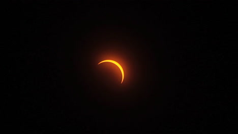 Zoom-out-on-sliver-of-sunlight-after-the-totality-phase-is-done-during-a-solar-eclipse