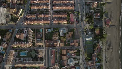 High-aerial-descending-view-over-houses-of-Rincon-De-La-Victoria,-Malaga-Spain