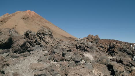 Peak-of-Pico-del-Teide-volcano-behind-rocks-on-Tenerife,-Canary-Islands-in-spring