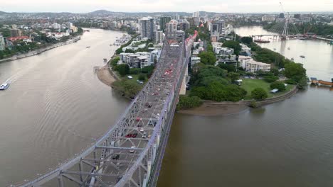Zoomed-drone-footage-taken-adjacent-to-the-Story-Bridge-looking-towards-Kangaroo-Point-near-Brisbane,-Queensland-in-Australia-looking-over-the-Brisbane-River-at-sunset