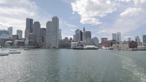 Boston-Harbor-view-of-the-cities-downtown-scape-from-a-ferry-on-a-sunny-day-in-4k