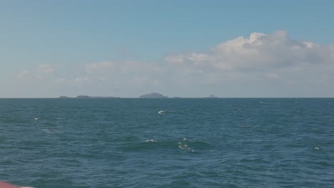 Hand-held-shot-of-a-boat-sailing-towards-the-Treshnish-Isles-on-the-horizon
