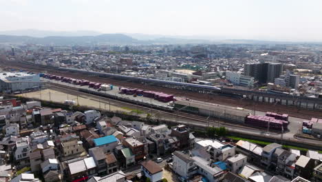 Aerial-View-Of-Cityscape-And-Shinkansen-Arriving-To-Kyoto-Train-Station-In-Japan---Drone-Shot
