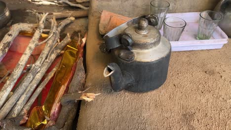 Pan-shot-of-Tea-being-prepared-in-old-aluminium-kettle-in-local-Dhaba-in-Bihari-Style