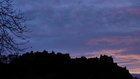 Silhouette-of-Edinburgh-Castle-at-sunset-on-a-winter's-night,-Scotland