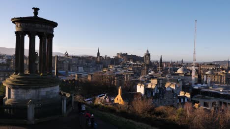 View-of-Dugald-Stewart-Monument,-Edinburgh-Castle-and-city-skyline-from-Calton-Hill-on-a-winters-morning,-Scotland