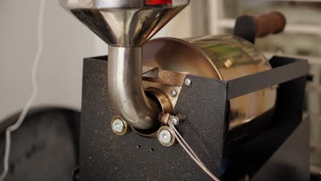 Closeup-coffee-making-machine-for-heating-grains-worker-production-roast-process