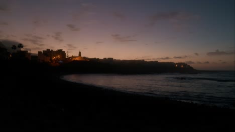 Blue-hour,-slowmotion-waves-on-beeble-beach-in-Playa-La-Caleta-de-Interián-on-Tenerife-during-dusk,-Canary-Islands