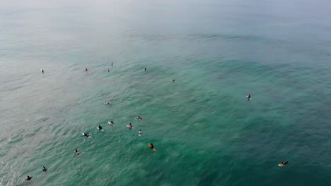 Aerial-Drone-View-of-Surfers-Wading-and-Chilling-on-Surfboards-in-Ocean-in-Sri-Lanka